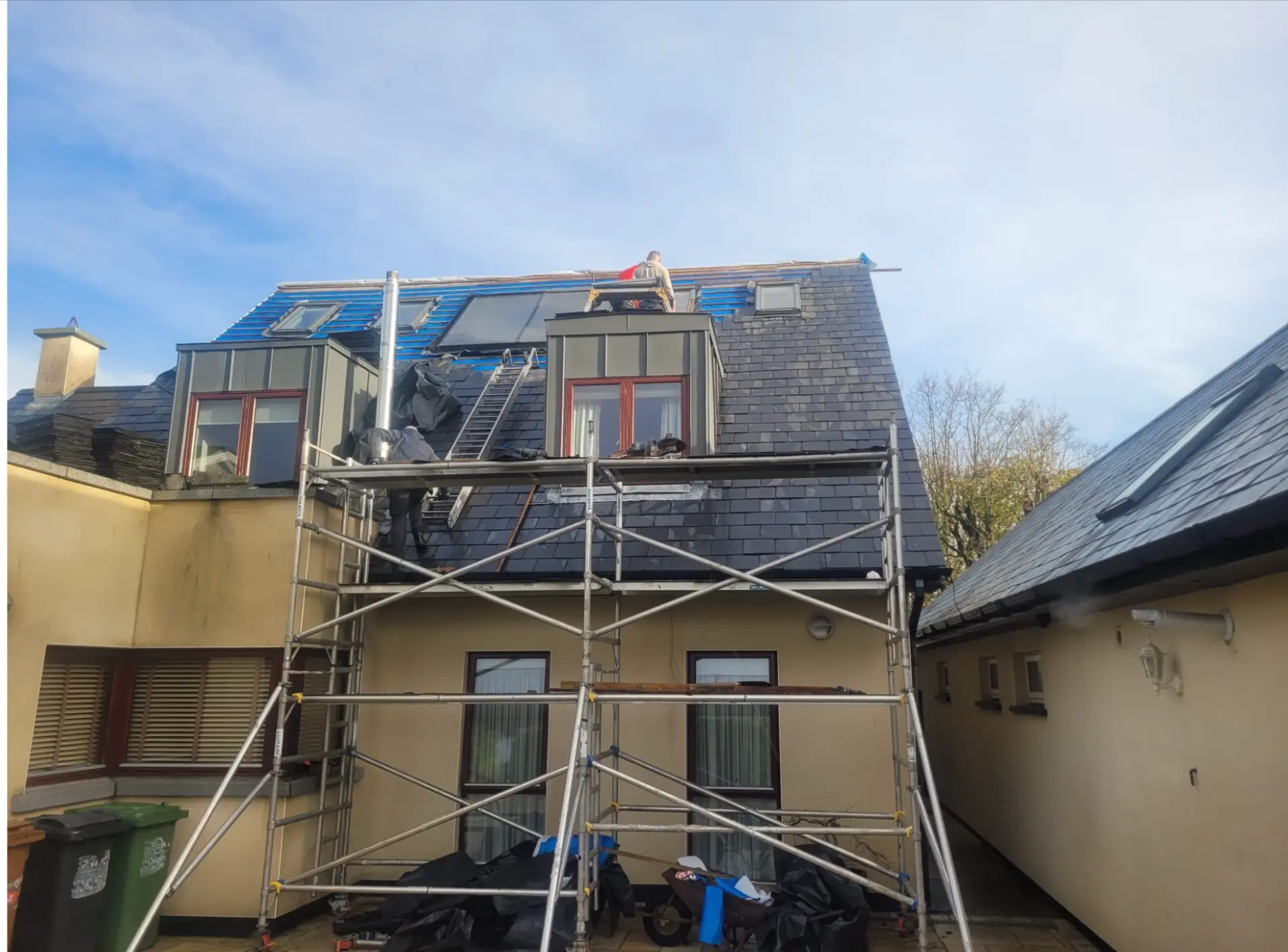Slate roof replacement in progress with scaffolding on a Dublin home