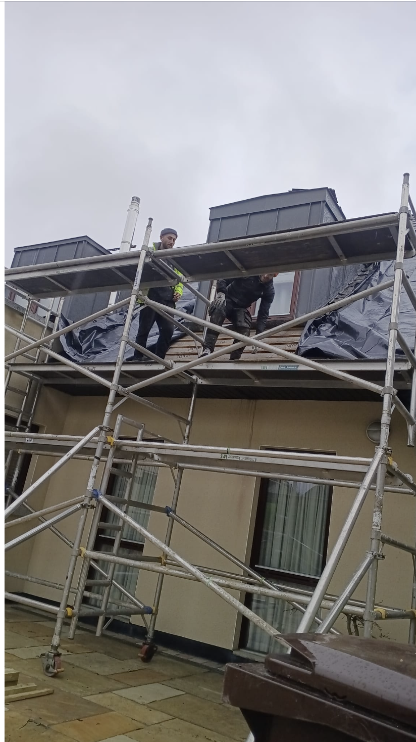 Roofers sheeting a Dublin roof to keep it watertight during works